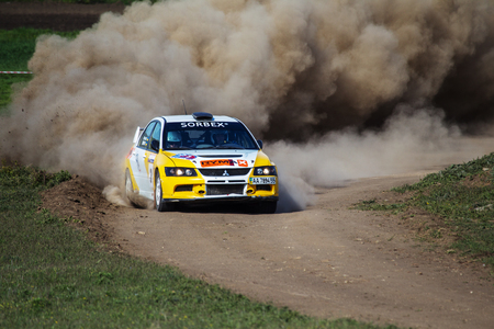 ODESSA, UKRAINE - April 30, 2017: Traditional rally Autocross Championship. Racing car is dangerous enters steep turn of race course, scattering, spraying dirt, dust. Extreme rally driving autocrossのeditorial素材