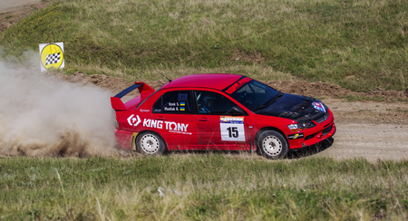 ODESSA, UKRAINE - April 30, 2017: Traditional rally Autocross Championship. Racing car is dangerous enters steep turn of race course, scattering, spraying dirt, dust. Extreme rally driving autocrossのeditorial素材