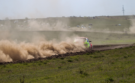 ODESSA, UKRAINE - April 30, 2017: Traditional rally Autocross Championship. Racing car is dangerous enters steep turn of race course, scattering, spraying dirt, dust. Extreme rally driving autocrossのeditorial素材