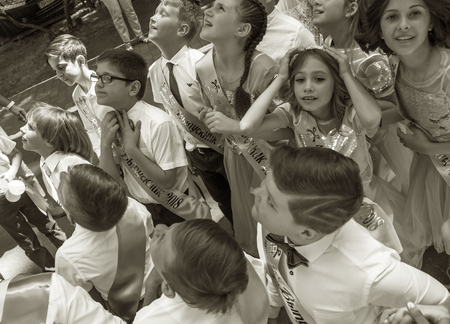 Odessa, Ukraine - May 31,2018: Children's musical group sing and dance on stage during graduation concert of elementary school. Children play. Emotional children's show on stage. Children's creativityのeditorial素材
