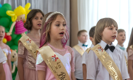 Odessa, Ukraine - May 31,2018: Children's musical group sing and dance on stage during graduation concert of elementary school. Children play. Emotional children's show on stage. Children's creativityのeditorial素材