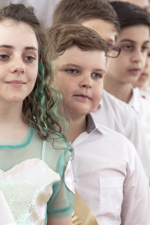 Odessa, Ukraine - May 31,2018: Children's musical group sing and dance on stage during graduation concert of elementary school. Children play. Emotional children's show on stage. Children's creativityのeditorial素材