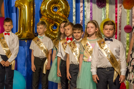 Odessa, Ukraine - May 31,2018: Children's musical group sing and dance on stage during graduation concert of elementary school. Children play. Emotional children's show on stage. Children's creativityのeditorial素材