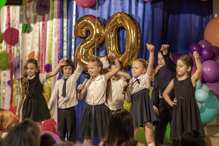 Odessa, Ukraine - May 31,2018: Children's musical group sing and dance on stage during graduation concert of elementary school. Children play. Emotional children's show on stage. Children's creativityのeditorial素材