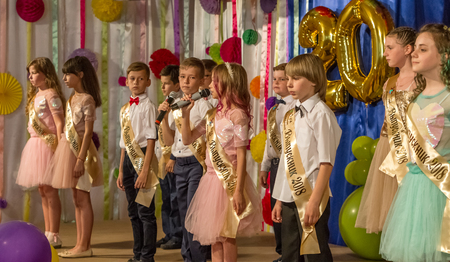 Odessa, Ukraine - May 31,2018: Children's musical group sing and dance on stage during graduation concert of elementary school. Children play. Emotional children's show on stage. Children's creativityのeditorial素材