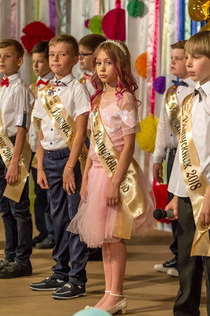 Odessa, Ukraine - May 31,2018: Children's musical group sing and dance on stage during graduation concert of elementary school. Children play. Emotional children's show on stage. Children's creativityのeditorial素材