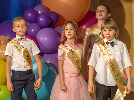 Odessa, Ukraine - May 31,2018: Children's musical group sing and dance on stage during graduation concert of elementary school. Children play. Emotional children's show on stage. Children's creativityのeditorial素材