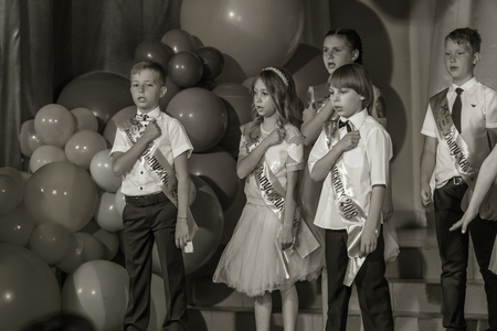 Odessa, Ukraine - May 31,2018: Children's musical group sing and dance on stage during graduation concert of elementary school. Children play. Emotional children's show on stage. Children's creativityのeditorial素材