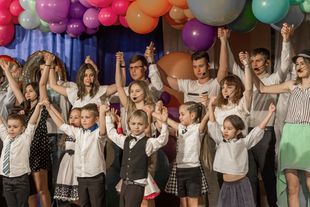 Odessa, Ukraine - May 31,2018: Children's musical group sing and dance on stage during graduation concert of elementary school. Children play. Emotional children's show on stage. Children's creativityのeditorial素材