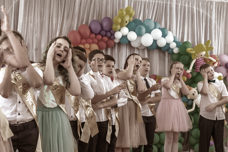 Odessa, Ukraine - May 31,2018: Children's musical group sing and dance on stage during graduation concert of elementary school. Children play. Emotional children's show on stage. Children's creativityのeditorial素材