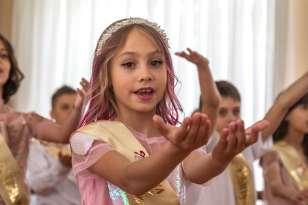 Odessa, Ukraine - May 31,2018: Children's musical group sing and dance on stage during graduation concert of elementary school. Children play. Emotional children's show on stage. Children's creativityのeditorial素材