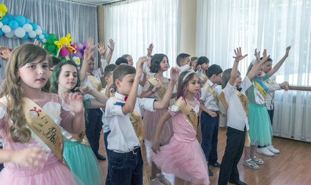 Odessa, Ukraine - May 31,2018: Children's musical group sing and dance on stage during graduation concert of elementary school. Children play. Emotional children's show on stage. Children's creativityのeditorial素材