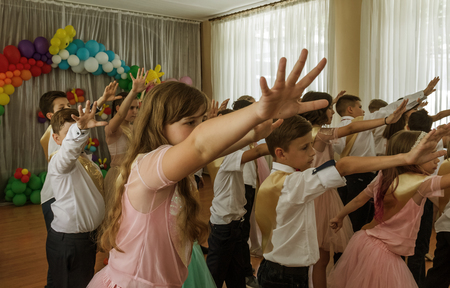 Odessa, Ukraine - May 31,2018: Children's musical group sing and dance on stage during graduation concert of elementary school. Children play. Emotional children's show on stage. Children's creativityのeditorial素材