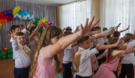 Odessa, Ukraine - May 31,2018: Children's musical group sing and dance on stage during graduation concert of elementary school. Children play. Emotional children's show on stage. Children's creativityのeditorial素材