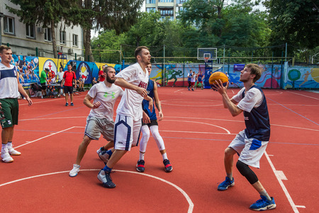 ODESSA, UKRAINE - JULY 28, 2018: Adolescents play basketball during 3x3 streetball championship. Young people play street basketball on an open city sports ground. Streetball - street culturesのeditorial素材