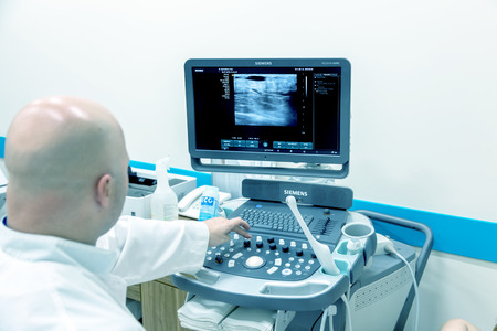 ODESSA, UKRAINE - July 29, 2018: Woman undergoes medical examination of veins on ultrasound sensor...