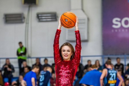 ODESSA, UKRAINE - March 15, 2018: Speech by the beautiful young girls of the fan team during the opening of the basketball championship. Team performance of the team on the parquet gymのeditorial素材