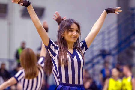 ODESSA, UKRAINE - March 15, 2018: Speech by the beautiful young girls of the fan team during the opening of the basketball championship. Team performance of the team on the parquet gymのeditorial素材