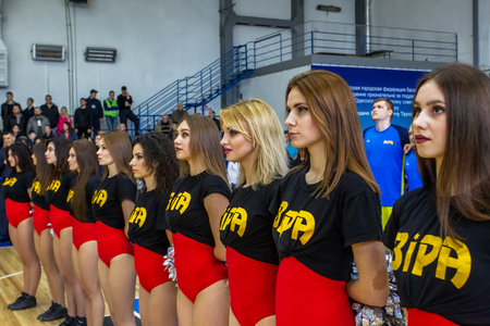 ODESSA, UKRAINE - March 15, 2018: Speech by the beautiful young girls of the fan team during the opening of the basketball championship. Team performance of the team on the parquet gymのeditorial素材