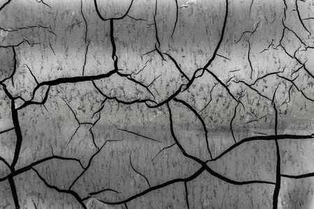 Background of old cracked paint. Large cracks on the surface. Close the layers; many paint and paper...