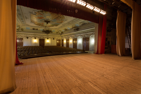 Mystical interior of old provincial Soviet theater of USSR. Stucco frescoes, nostalgic painting of walls and ceilings with fragments of revolutionary history USSR. Interior in luxurious Empire styleのeditorial素材
