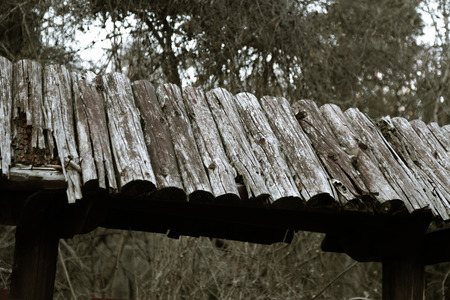Wood planks texture dark background or wallpaper. overlap wooden wall horizontally have damage of old. Dark brown rustic aged barn wood planks background. Space for text, copy, letteringの写真素材