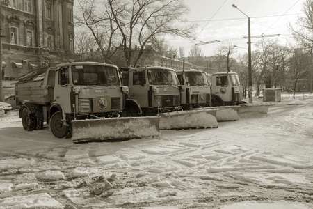 ODESSA, UKRAINE - JANUARY 27, 2019: Special snow removal vehicles on road during a snowfall. Front...