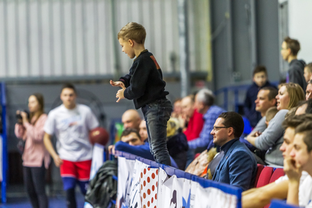 Odessa, Ukraine - Febr 16, 2019: Fans of basketball team and spectators in stands emotionally support their team during intense play. Fan club. Visitors fill stands of stadium. Fans celebrate successのeditorial素材
