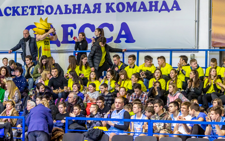 Odessa, Ukraine - Febr 16, 2019: Fans of basketball team and spectators in stands emotionally support their team during intense play. Fan club. Visitors fill stands of stadium. Fans celebrate successのeditorial素材