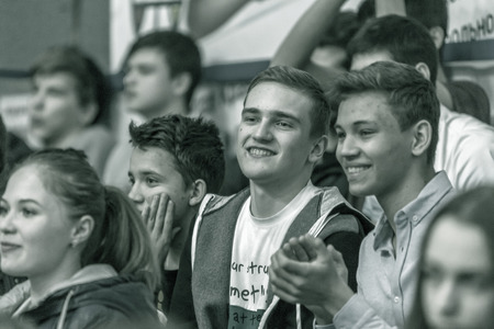 Odessa, Ukraine - Febr 16, 2019: Fans of basketball team and spectators in stands emotionally support their team during intense play. Fan club. Visitors fill stands of stadium. Fans celebrate successのeditorial素材