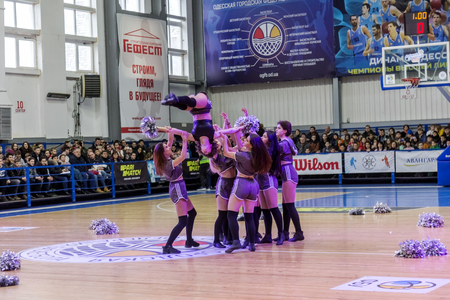 Odessa, Ukraine - Febr 16, 2019: Bright dynamic characteristics of a support group of women's sports team. Performance Support Group. Bright beautiful young girl in sports dance form on the playgroundのeditorial素材