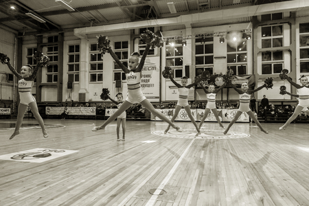 Odessa, Ukraine - Febr 16, 2019: Bright dynamic characteristics of a support group of women's sports team. Performance Support Group. Bright beautiful young girl in sports dance form on the playgroundのeditorial素材