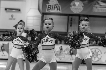 Odessa, Ukraine - Febr 16, 2019: Bright dynamic characteristics of a support group of women's sports team. Performance Support Group. Bright beautiful young girl in sports dance form on the playgroundのeditorial素材