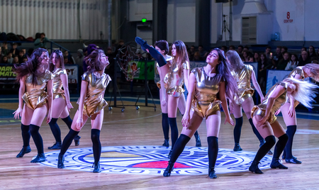 Odessa, Ukraine - Febr 16, 2019: Bright dynamic characteristics of a support group of women's sports team. Performance Support Group. Bright beautiful young girl in sports dance form on the playgroundのeditorial素材