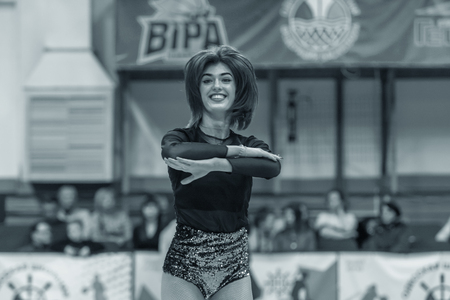 Odessa, Ukraine - Febr 16, 2019: Bright dynamic characteristics of a support group of women's sports team. Performance Support Group. Bright beautiful young girl in sports dance form on the playgroundのeditorial素材