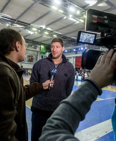 ODESSA, UKRAINE - February 16, 2019: Interview of captain of Ukrainian national basketball team Vyacheslav Kravtsov during opening of children's championship. Basketball player Vyacheslav Kravtsovのeditorial素材