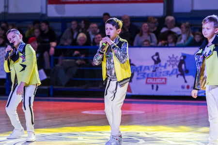 Odessa, Ukraine - February 16, 2019: Children's music groups singing and dancing on basketball court during a commercial break. Children's play. Emotional children's show on stage. Dancing on stageのeditorial素材