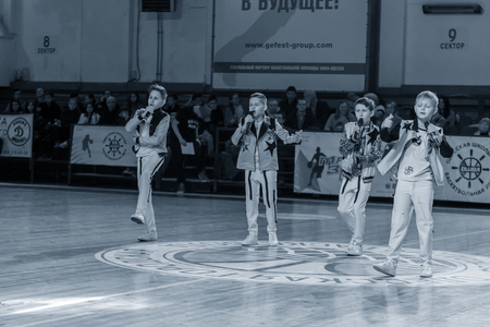Odessa, Ukraine - February 16, 2019: Children's music groups singing and dancing on basketball court during a commercial break. Children's play. Emotional children's show on stage. Dancing on stageのeditorial素材