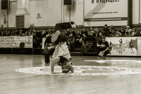 Odessa, Ukraine - February 16, 2019: street dancers, children and teenagers dance break dance on the basketball court during the commercial break. Hip-hop dancers perform at the sports arenaのeditorial素材
