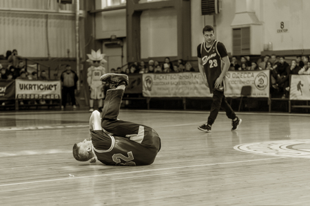 Odessa, Ukraine - February 16, 2019: street dancers, children and teenagers dance break dance on the basketball court during the commercial break. Hip-hop dancers perform at the sports arenaのeditorial素材
