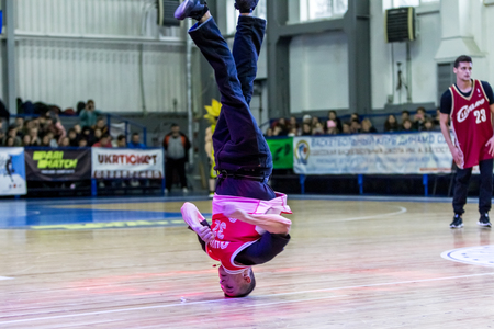 Odessa, Ukraine - February 16, 2019: street dancers, children and teenagers dance break dance on the basketball court during the commercial break. Hip-hop dancers perform at the sports arenaのeditorial素材