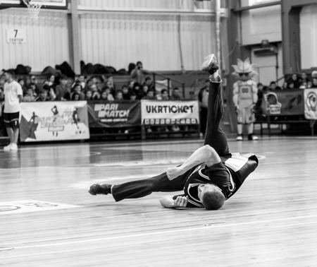 Odessa, Ukraine - February 16, 2019: street dancers, children and teenagers dance break dance on the basketball court during the commercial break. Hip-hop dancers perform at the sports arenaのeditorial素材