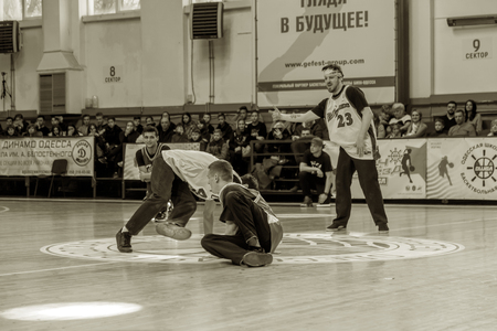 Odessa, Ukraine - February 16, 2019: street dancers, children and teenagers dance break dance on the basketball court during the commercial break. Hip-hop dancers perform at the sports arenaのeditorial素材