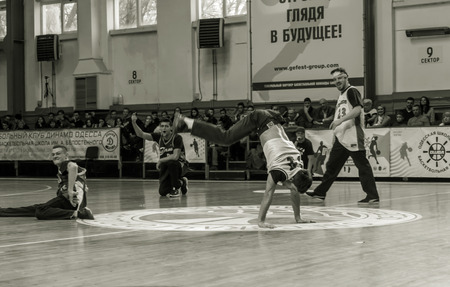 Odessa, Ukraine - February 16, 2019: street dancers, children and teenagers dance break dance on the basketball court during the commercial break. Hip-hop dancers perform at the sports arenaのeditorial素材