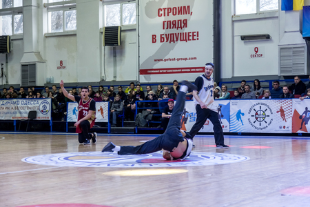 Odessa, Ukraine - February 16, 2019: street dancers, children and teenagers dance break dance on the basketball court during the commercial break. Hip-hop dancers perform at the sports arenaのeditorial素材