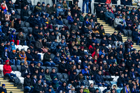 ODESSA, UKRAINE -2 March 2019: Crowds of fans in the stands of the football stadium during the match Shakhtar (Donetsk). Spectators at the stadium. Fayer, lights in the stadiums football stadiumのeditorial素材