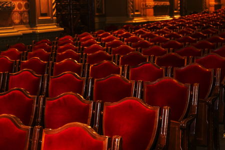 Interior theater art. Audience with empty soft armchairs of Opera and Ballet Theater is waiting for audience. Empty interior of concert theater before performance and without spectators. Soft focusの写真素材