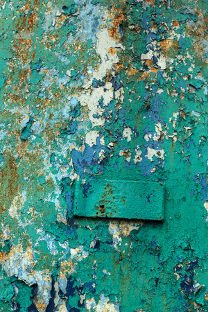 Rusty metal wall, old iron sheet, covered with rust with multi-colored paint. Trace of remnant of old paint in large deep crack on texture of surface rusty metal. Background texture old paint on metalの写真素材