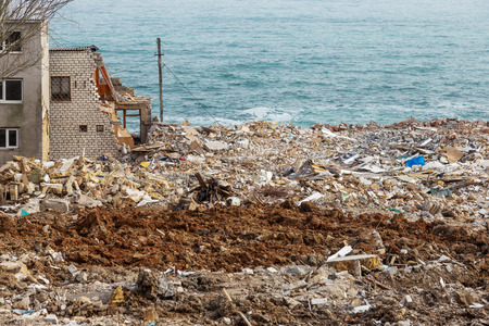 Landslide caused by rains of hurricane destroyed expensive cottages and houses. Destroyed house,...