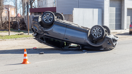 ODESSA, UKRAINE March 19, 2019: after car accident, broken car rolled over and lay down on roof on road that other cars drive. Concept of careless driving, breaking rules and speeding on roadのeditorial素材